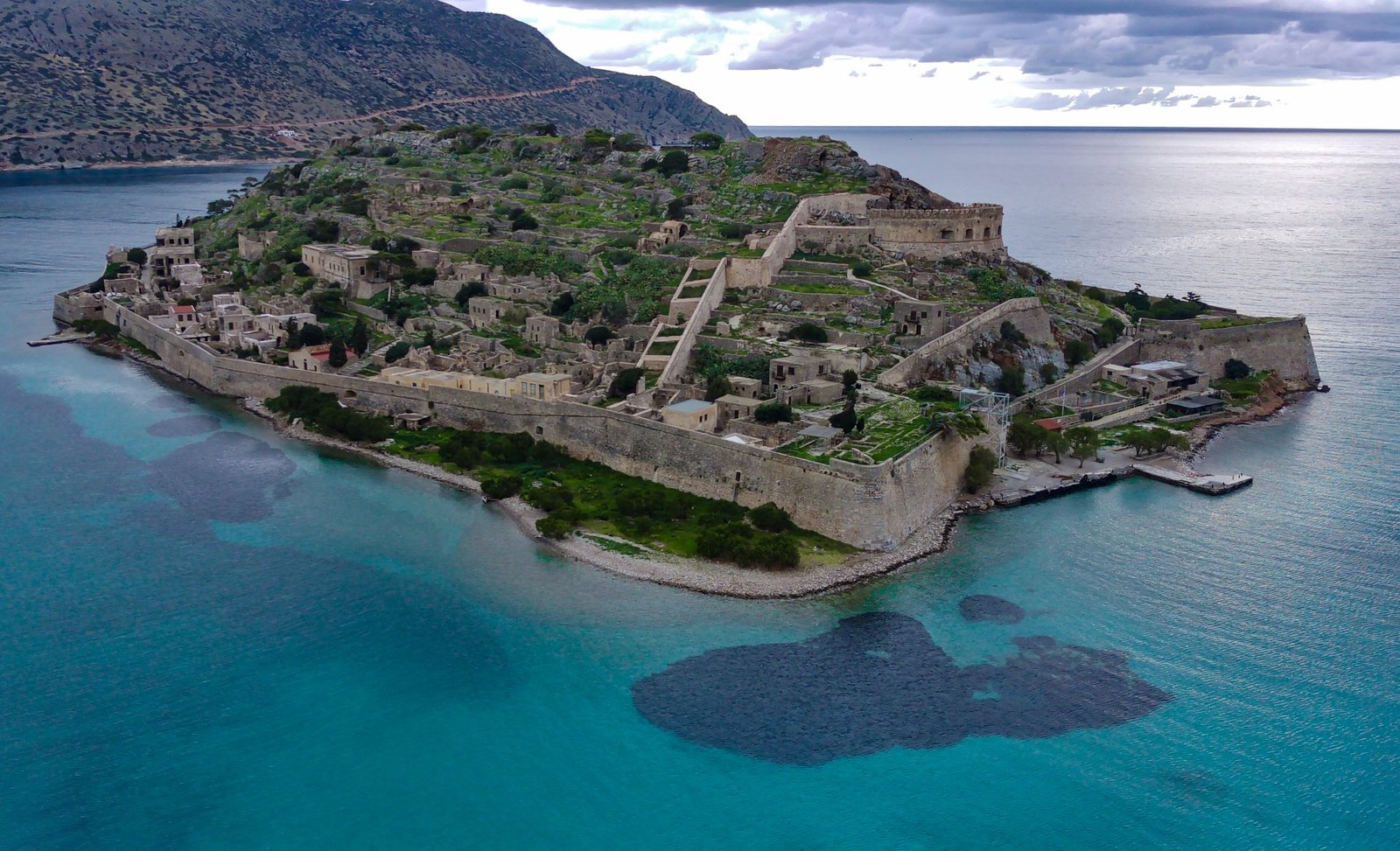 View-of-Spinalonga-Island-fortress-walls-and-turquoise-waters-near-Elounda-Crete