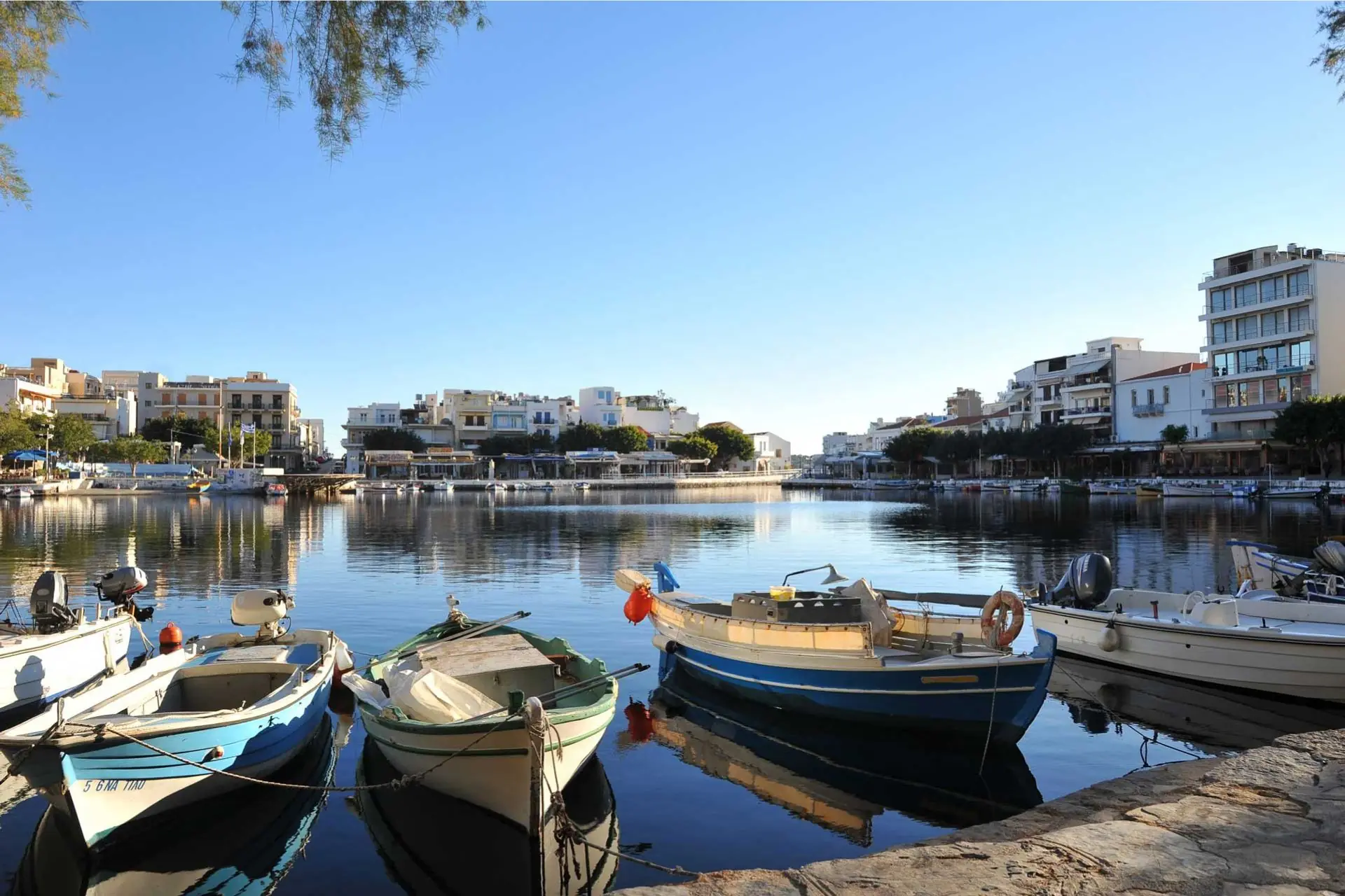 https://riasapartment.com/wp-content/uploads/2026/05/rias-apartment-agios-nikolaos-lake-voulismeni-boats.webp